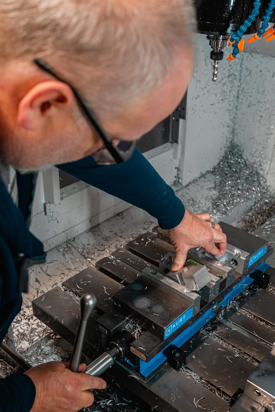 A CNC machine cutting an aluminum component on the FWM shop floor