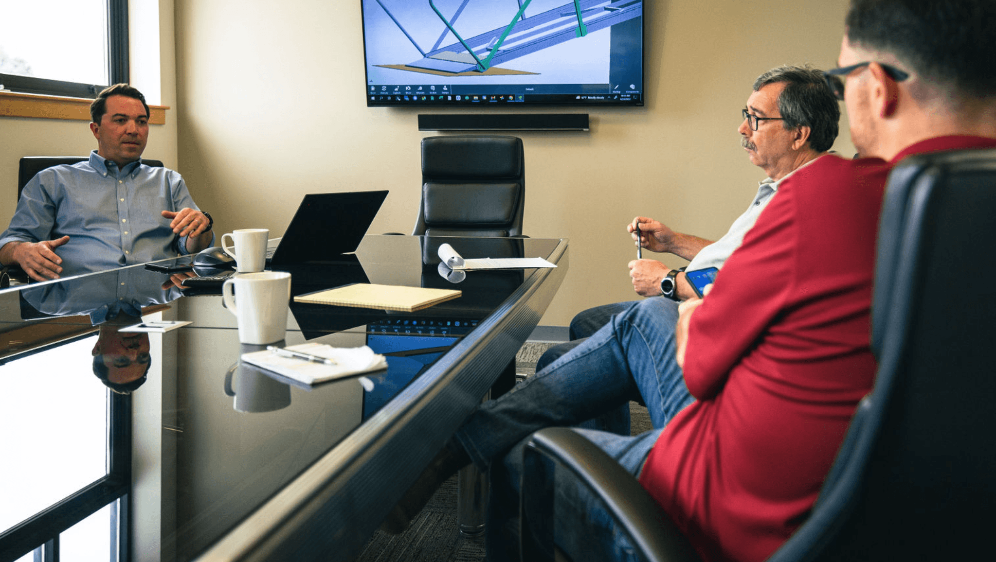 FWM engineers reviewing a customer CAD model on screen during a manufacturability review