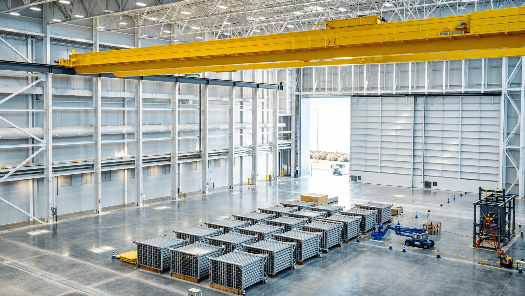 FWM's high-bay manufacturing facility with an overhead bridge crane and rows of finned-aluminum vaporizers staged on the production floor